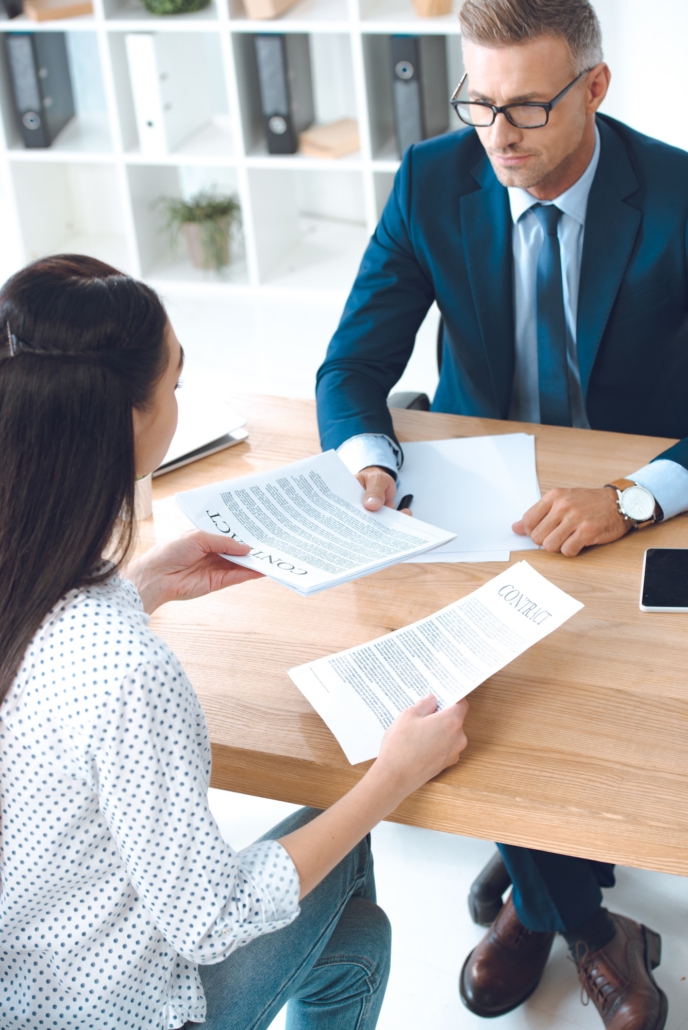 high angle view of lawyer and client discussing contract