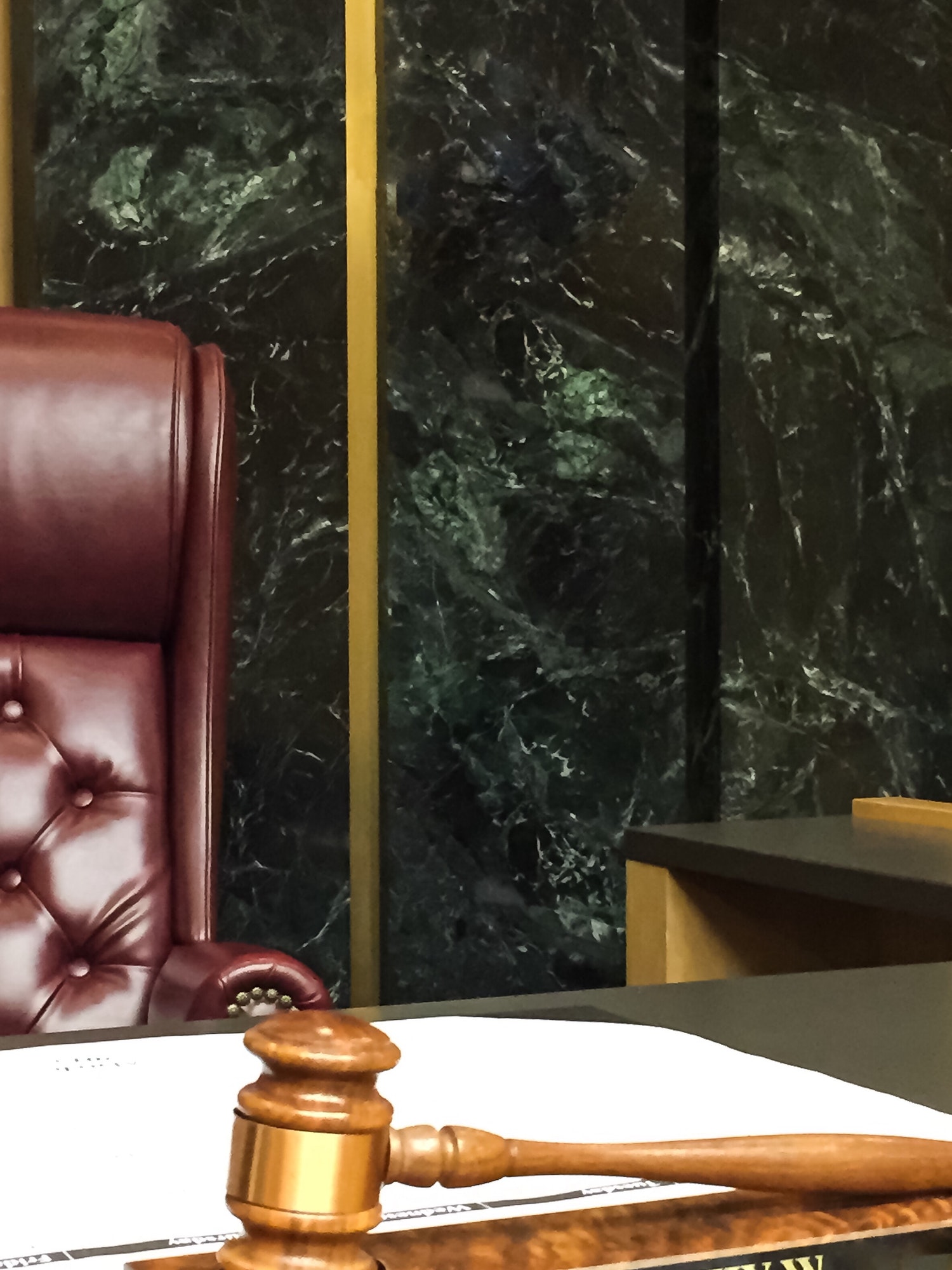 Approaching the bench in a courtroom with gavel and judge seat for law and order trial proceedings