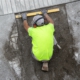 Construction worker with construction level working on a sidewalk