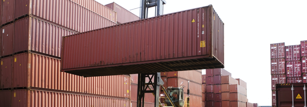 Person Transporting Cargo Container From Forklift In Commercial Dock