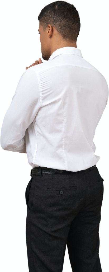 a man in a white shirt and black pants adjusting his collar