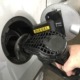 Person filling the car with diesel at the gas station, close-up.