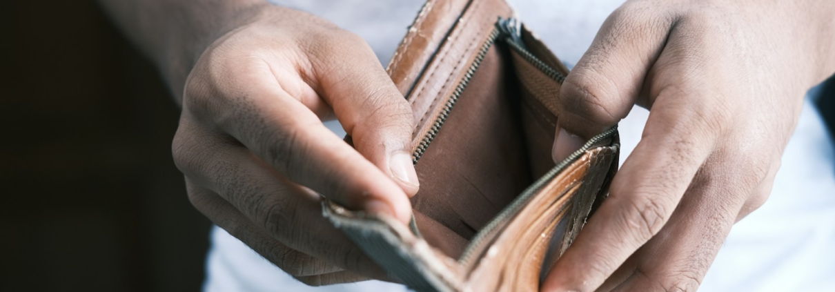 person holding brown leather bifold wallet