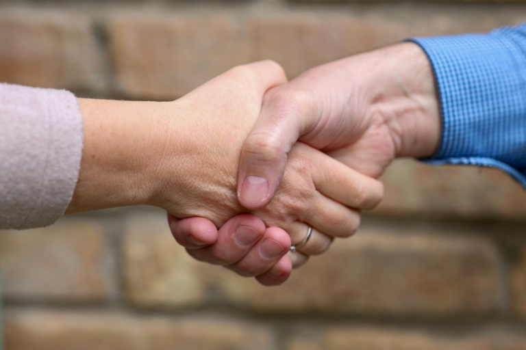 Two people are shaking hands.